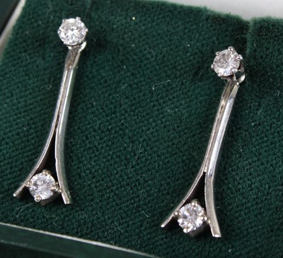 Lot 2699 - A pair of white metal diamond drop earrings,...