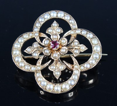 Lot 2702 - A yellow metal, pearl and ruby quatrefoil...