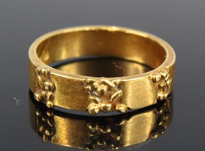 Lot 2718 - An 18ct gold wedding band, dispersed with...