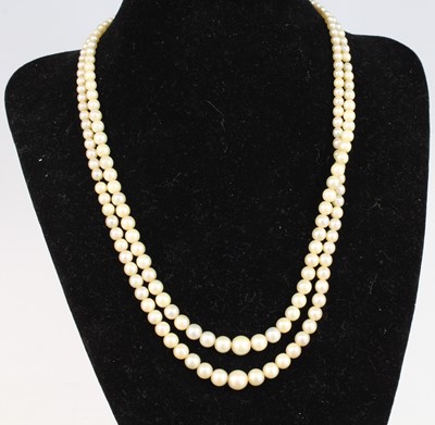 Lot 2751 - A cultured pearl double string choker, the two...