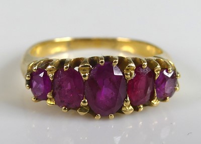 Lot 2766 - A yellow metal ruby half hoop eternity ring...