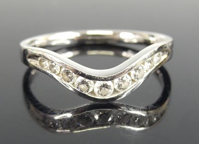 Lot 2768 - A platinum diamond wishbone style half hoop...