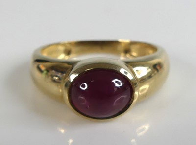 Lot 2770 - A 9ct yellow gold ruby dress ring featuring an...