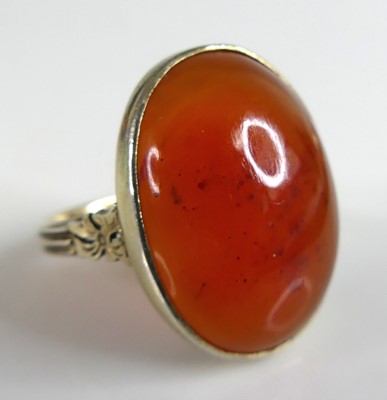 Lot 2773 - A yellow metal carnelian dress ring, the oval...