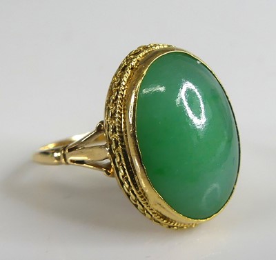 Lot 2774 - A yellow metal jadeite dress ring comprising a...