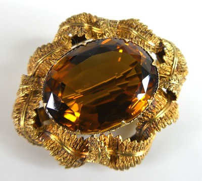 Lot 2777 - A yellow metal citrine brooch featuring an...