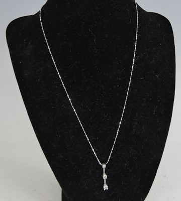 Lot 2622 - A white metal diamond bar pendant, featuring...