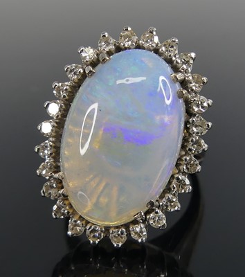 Lot 2644 - A white metal, opal and diamond oval cluster...