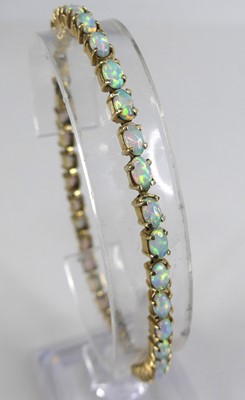 Lot 2618 - A yellow metal opal tennis bracelet,...