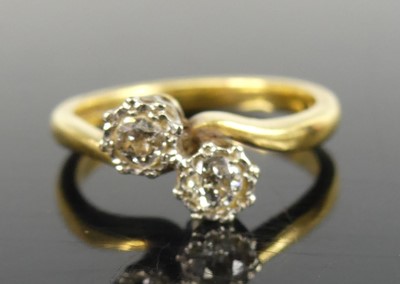 Lot 2684 - An 18ct gold diamond crossover ring arranged...