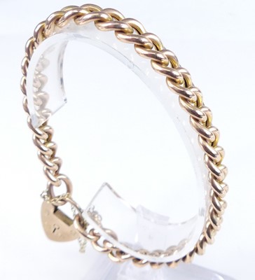 Lot 2797 - A 9ct gold curb link bracelet with heart...