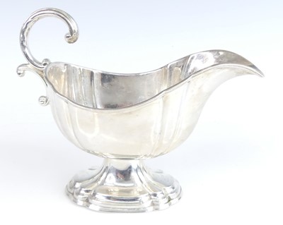 Lot 2124 - A George V silver sauceboat, having reeded...