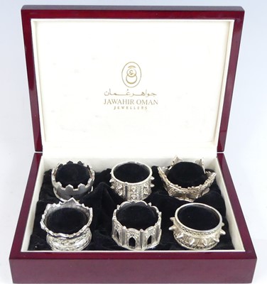 Lot 2146 - A cased set of six Omani silver napkin rings...