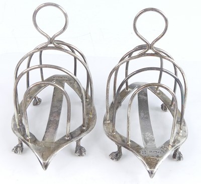 Lot 2096 - A pair of late Victorian silver toast racks,...