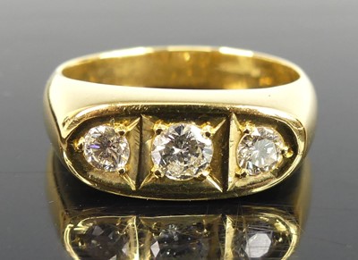 Lot 2748 - A heavy yellow metal diamond three-stone ring,...