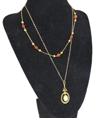 Lot 2812 - A 9ct gold and cabochon agate set pendant, on...