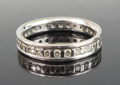 Lot 2823 - A white metal diamond eternity ring, arranged...