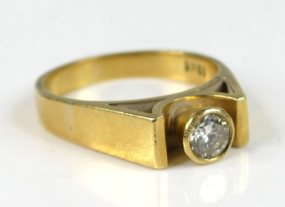 Lot 2835 - An 18ct gold diamond solitaire ring, the bezel...