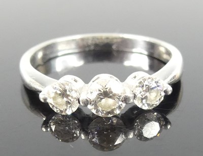 Lot 2837 - A contemporary platinum diamond trilogy ring,...