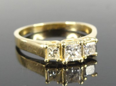 Lot 2843 - A modern 14ct gold diamond three-stone ring,...