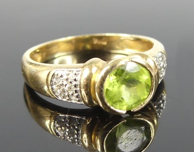 Lot 2848 - A 9ct gold peridot and diamond point set dress...