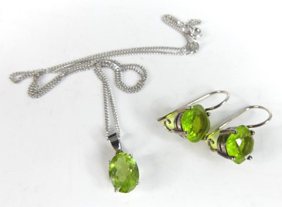 Lot 2862 - A 9ct gold white gold peridot set pendant, the...