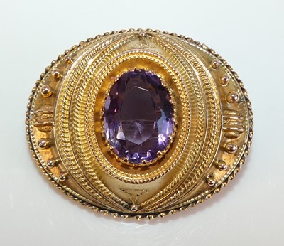 Lot 2191 - A yellow metal amethyst oval target brooch...