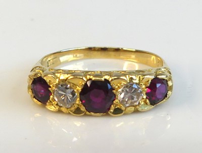 Lot 2173 - A yellow metal ruby and diamond half hoop...