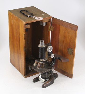 Lot 24 - A 20th century iron monocular microscope...