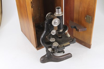 Lot 24 - A 20th century iron monocular microscope...