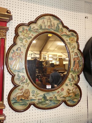 Lot 1125 - A walnut shaped oval wall mirror, the frame...