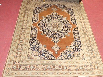 Lot 1132 - A Persian woollen sarouk rug, having trailing...