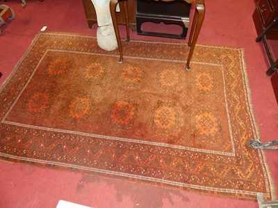 Lot 1134 - A Persian woollen rust ground bokhara rug, 208...