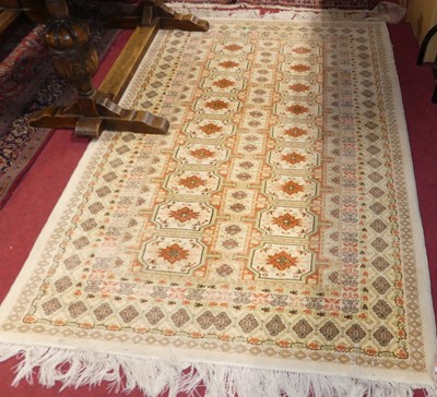 Lot 1138 - A Persian woollen cream ground bokara rug, 190...