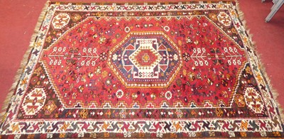 Lot 1144 - A Persian woollen red ground shiraz rug, 165 x...