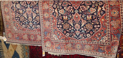 Lot 1148 - A pair of Persian red and blue ground Isfahan...