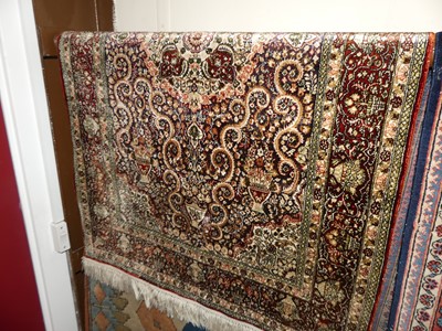 Lot 1149 - A small Persian silk woven red ground tabriz...