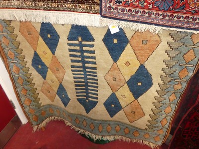 Lot 1150 - A caucasian woollen cream ground rug, with all...