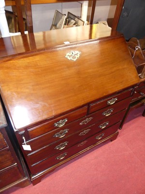 Lot 1218 - A George III mahogany slopefront writing...