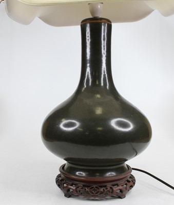 Lot 83 - A Chinese green glazed stoneware vase of squat...