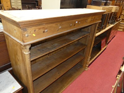 Lot 1233 - A large stained pine two-tier freestanding...