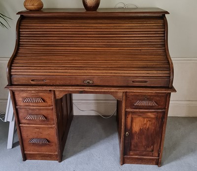 Lot 1257 - A 1930s oak rolltop desk, one pedestal fitted...