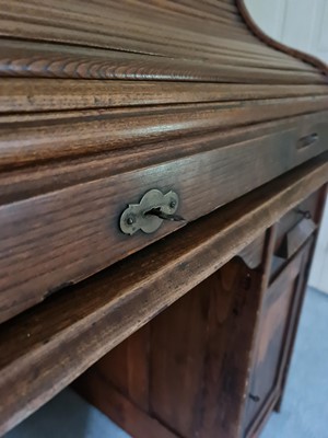 Lot 1257 - A 1930s oak rolltop desk, one pedestal fitted...
