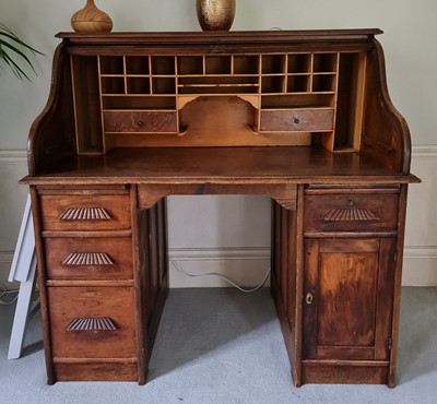 Lot 1257 - A 1930s oak rolltop desk, one pedestal fitted...