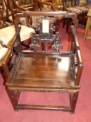 Lot 1301 - A Chinese 'rosewood' panelled seat elbow chair,...