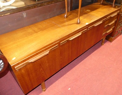 Lot 1360 - A 1960s Uniflex teak long sideboard, having...