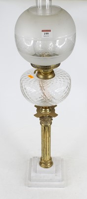 Lot 199 - A 20th century oil lamp having clear glass...