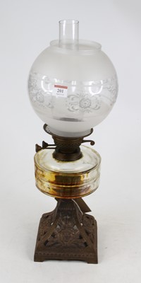 Lot 201 - A 20th century oil lamp having a clear glass...