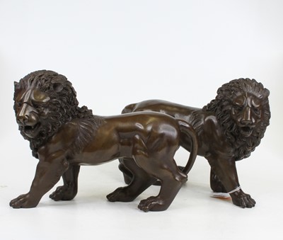 Lot 242 - A pair of bronzed metal figures of lions...