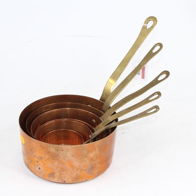 Lot 250 - A set of six graduated copper saucepans with...